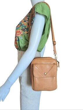 Minooy. Thea Crossbody Bag. It is a compact, vertical leather shoulder bag pop